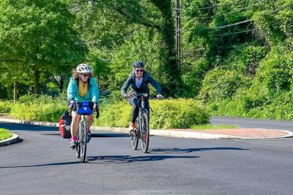 2 people biking on the road