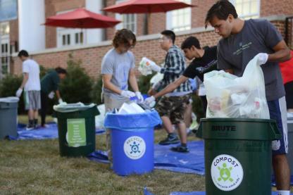 students sorting trash, recycling and compost in a waste audit outdoors