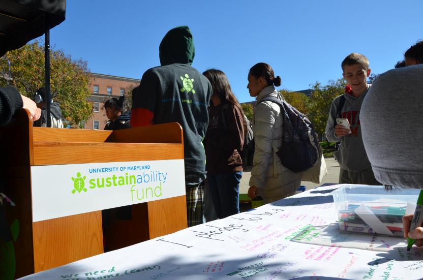 Image of the Outreach Bike and students standing around it