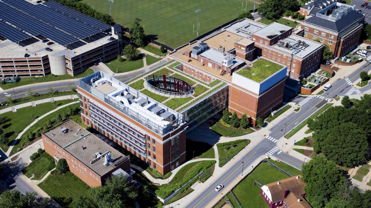 Aerial shot of buildings, green space and solar panels
