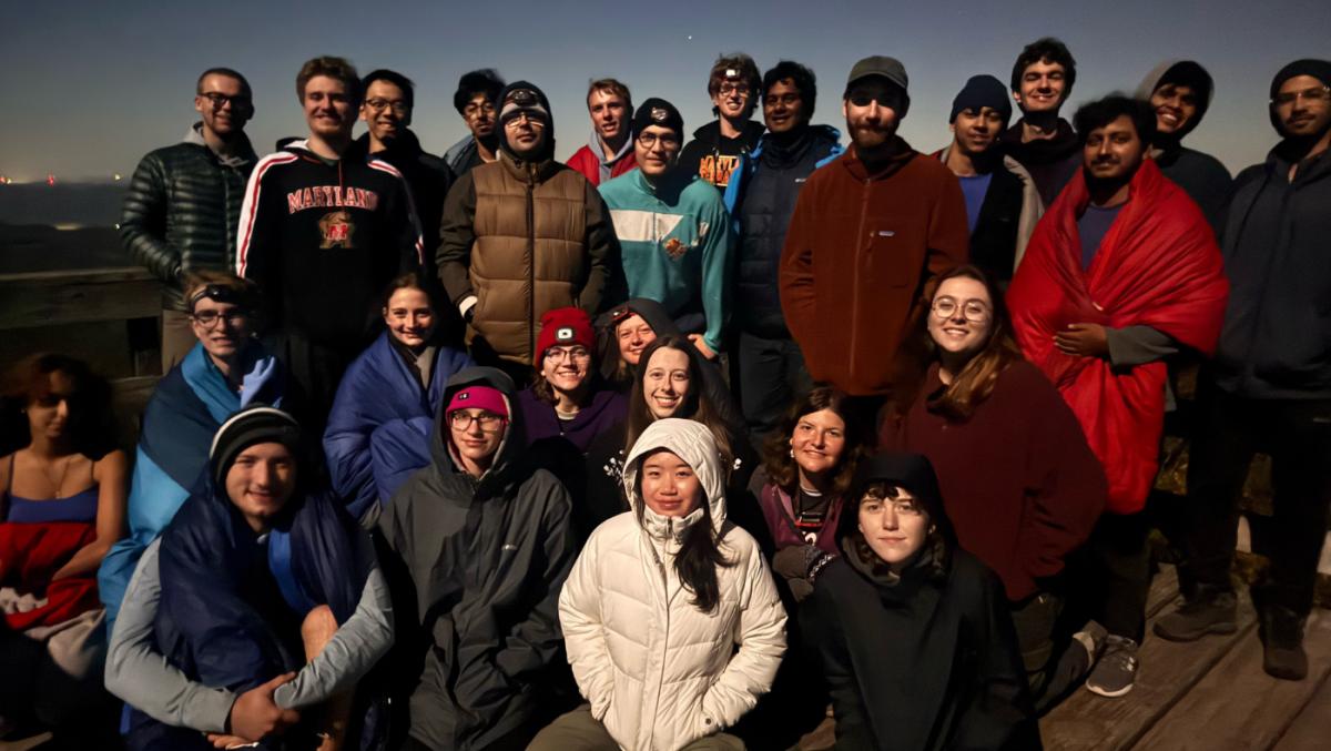 Many students posing for a picture while hiking