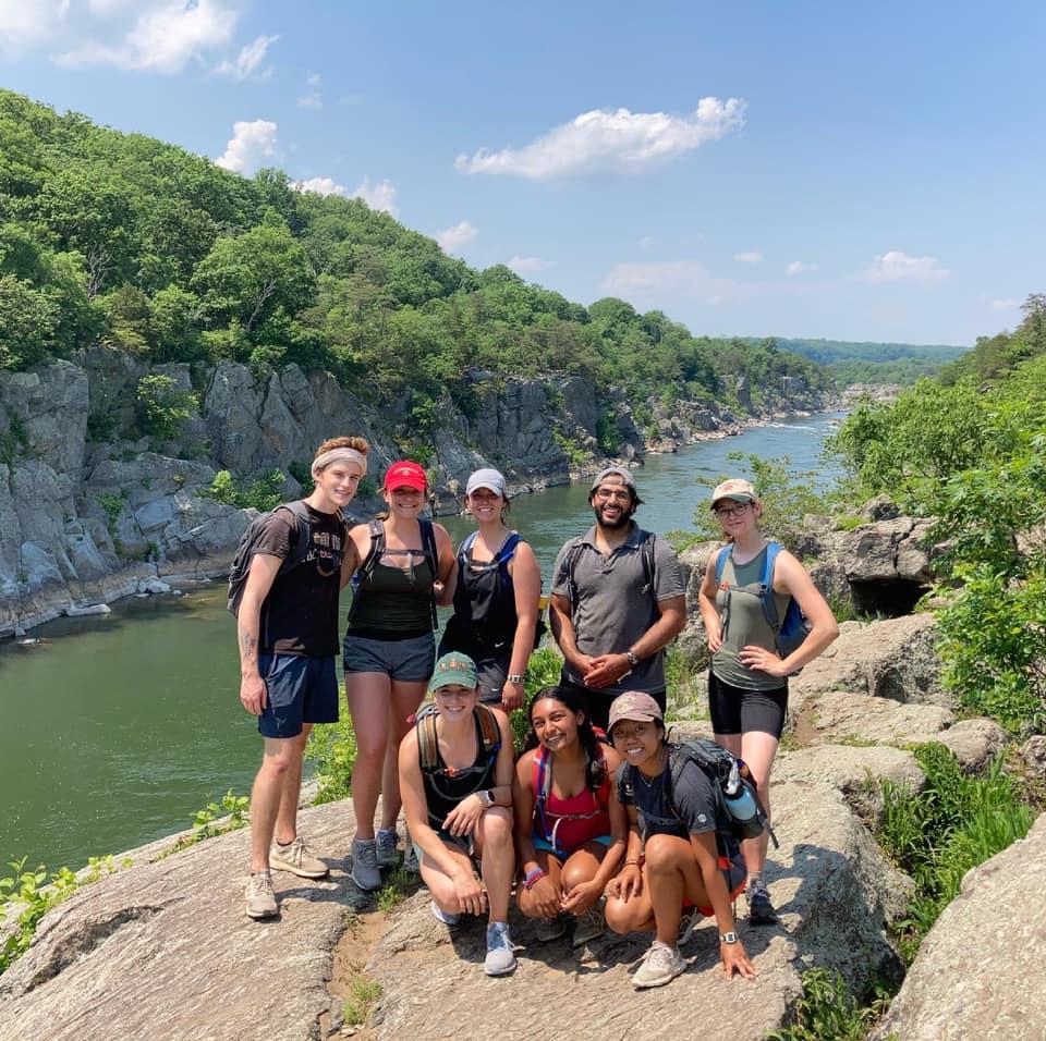 Group of Students posed together in front of a mountain/river landscape overlook