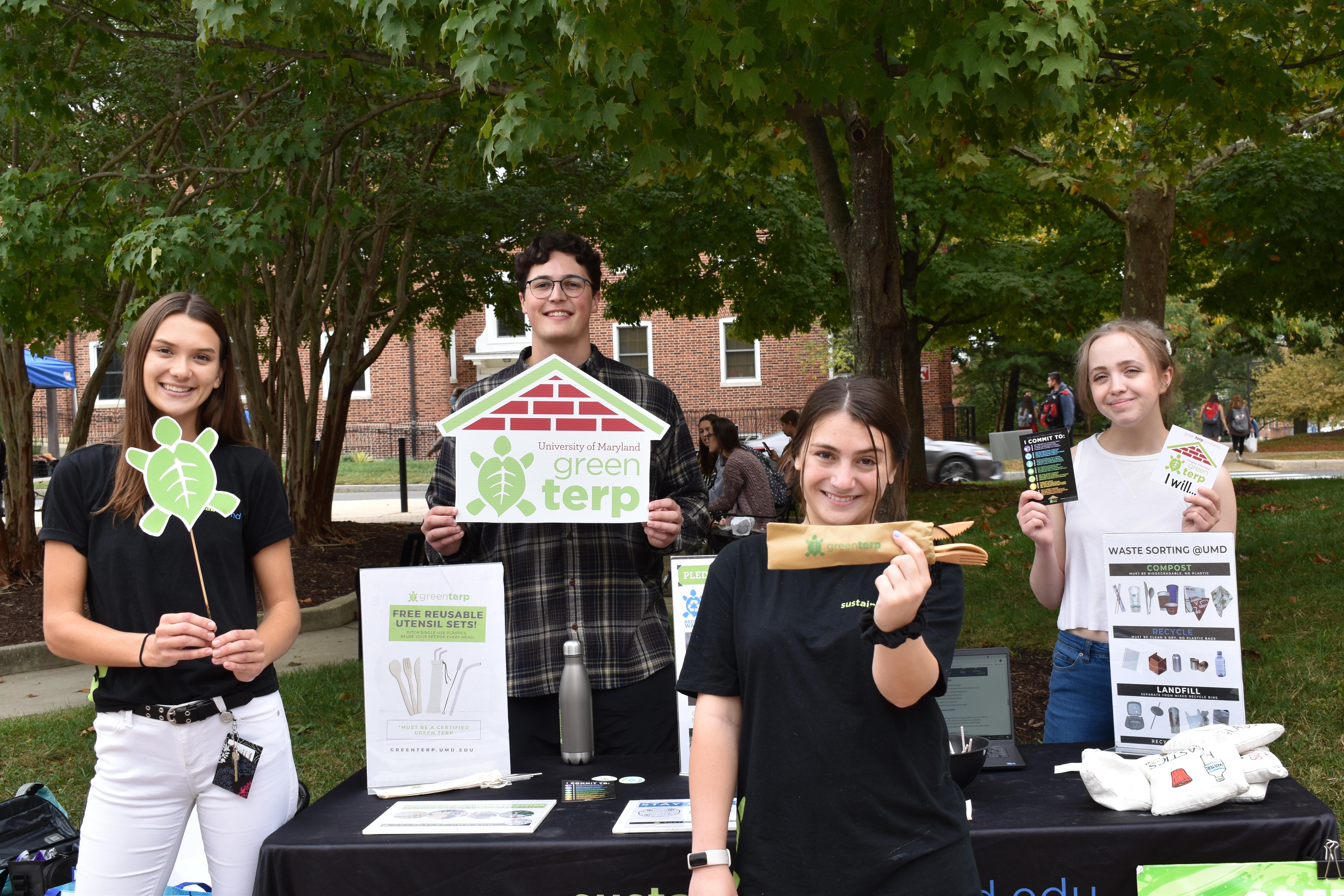 Outreach Team Tabling at the Farmers Market wearing SustainableUMD shirts