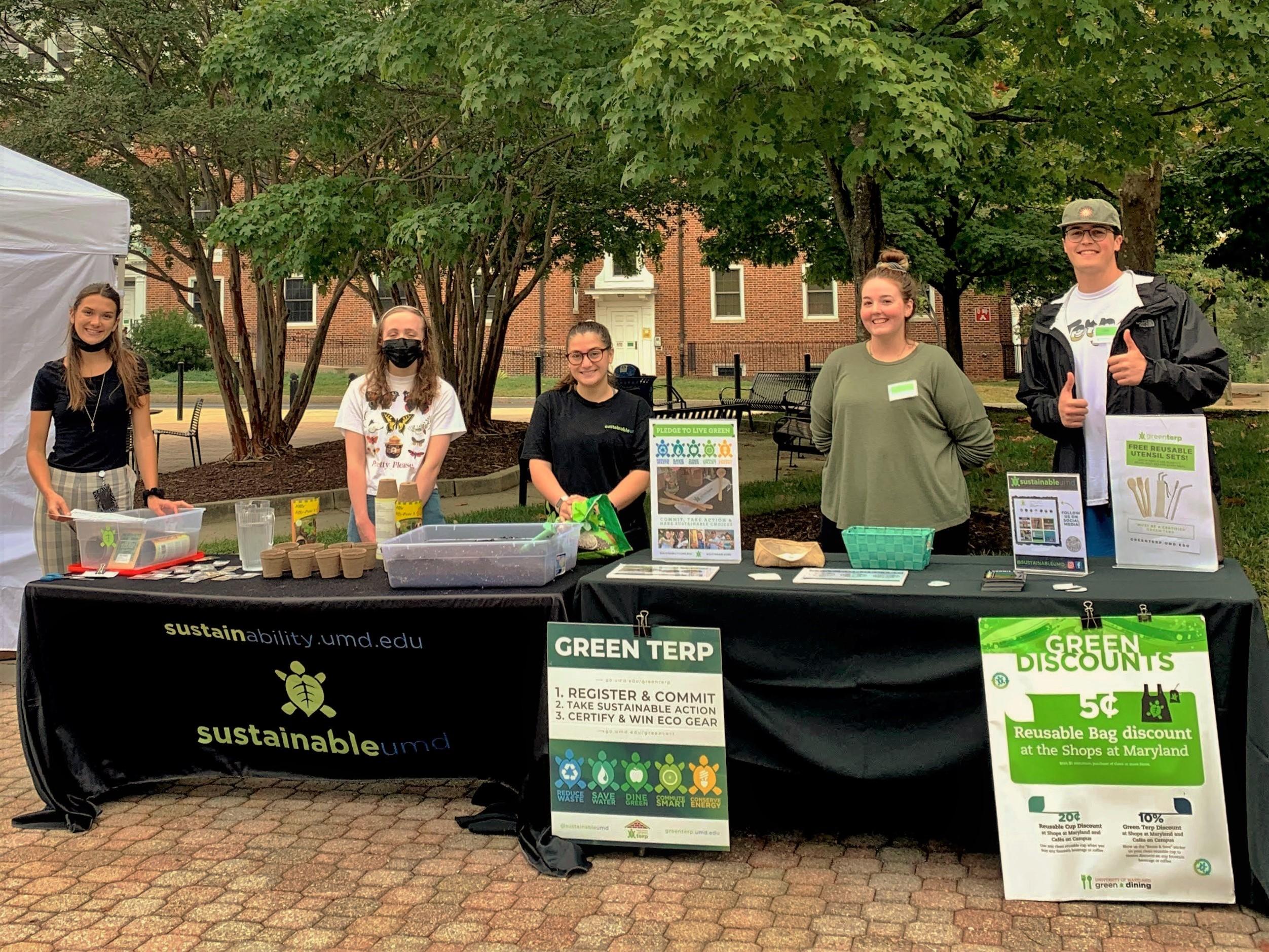 Outreach Team Tabling at the Farmers Market wearing SustainableUMD shirts