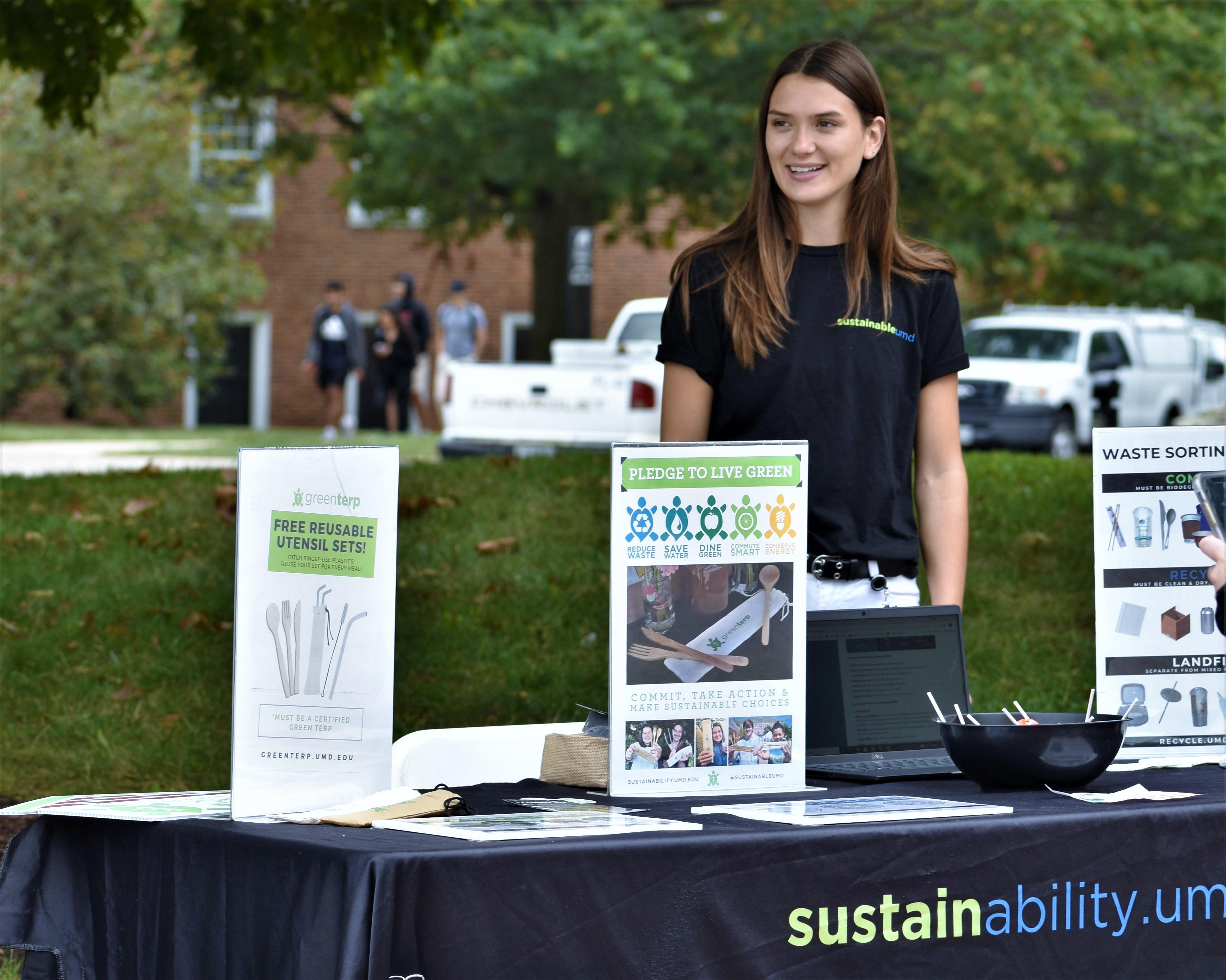 Outreach Team Tabling at the Farmers Market wearing SustainableUMD shirts