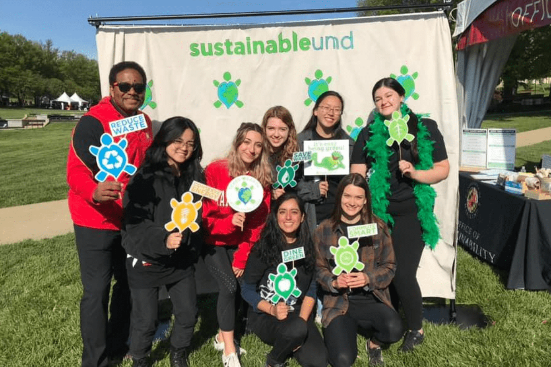 President Pines, staff, and students at sustainability photo booth