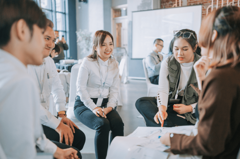 Staff collaborate in a circle