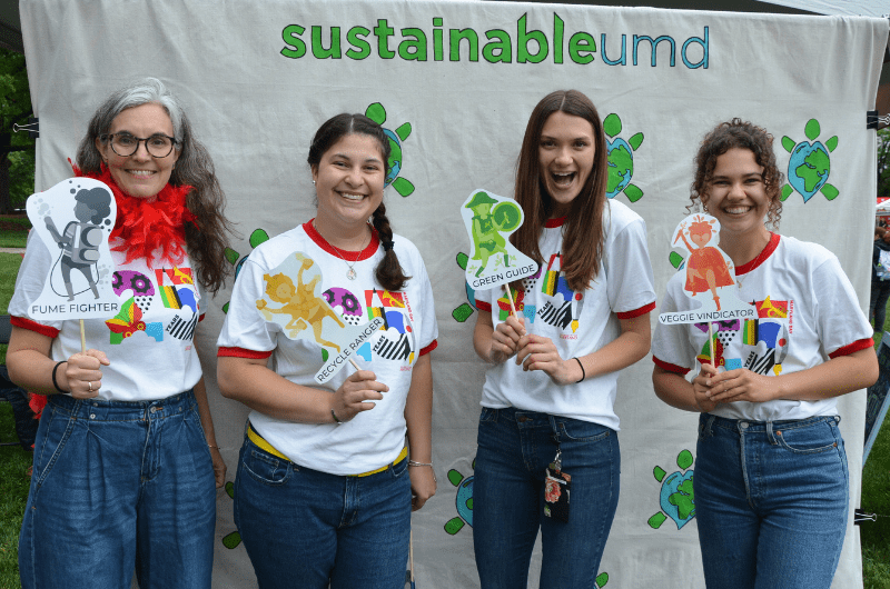 Staff holding props at photo booth