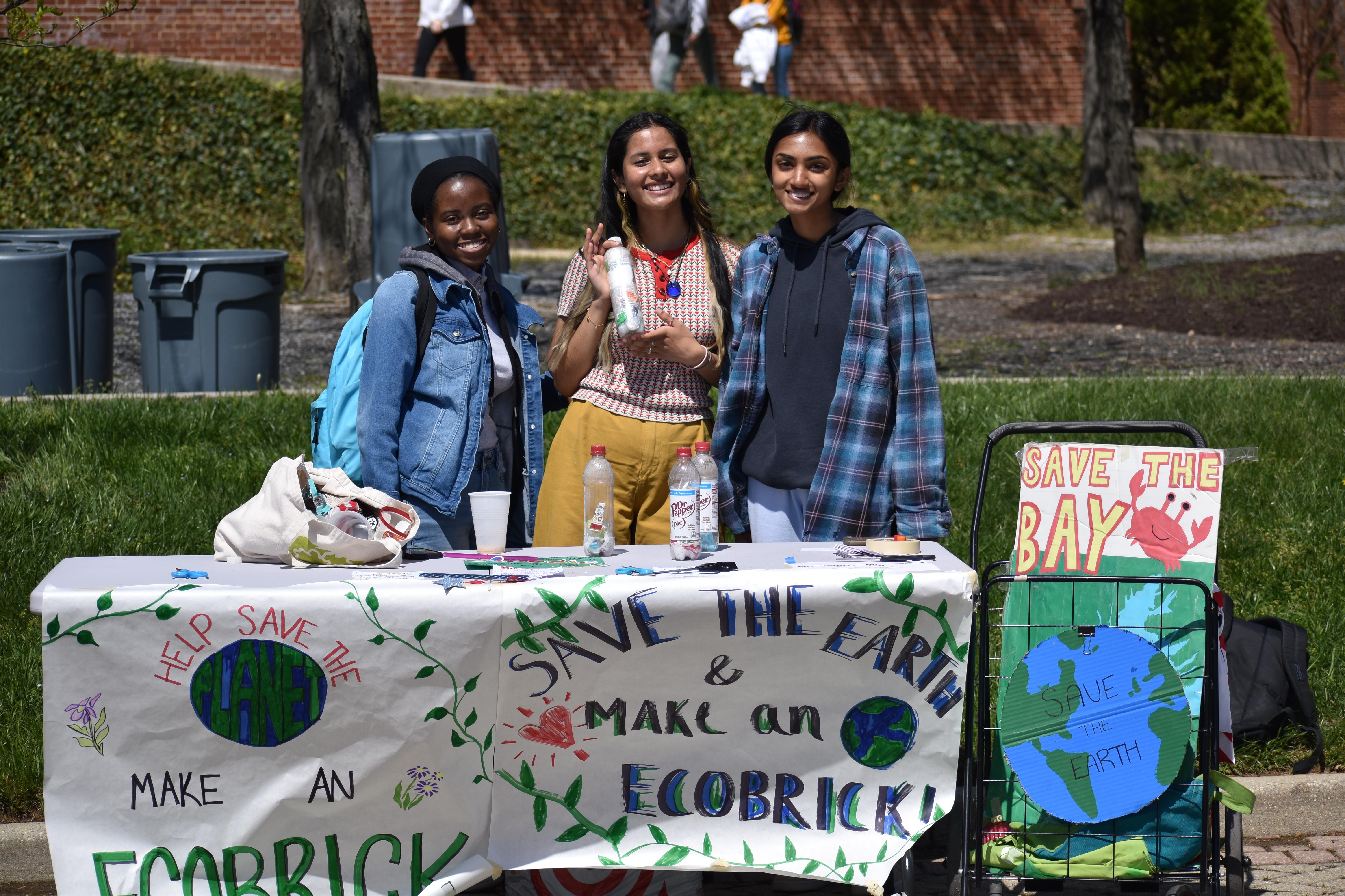 Students tabling and holding ecobrick bottles