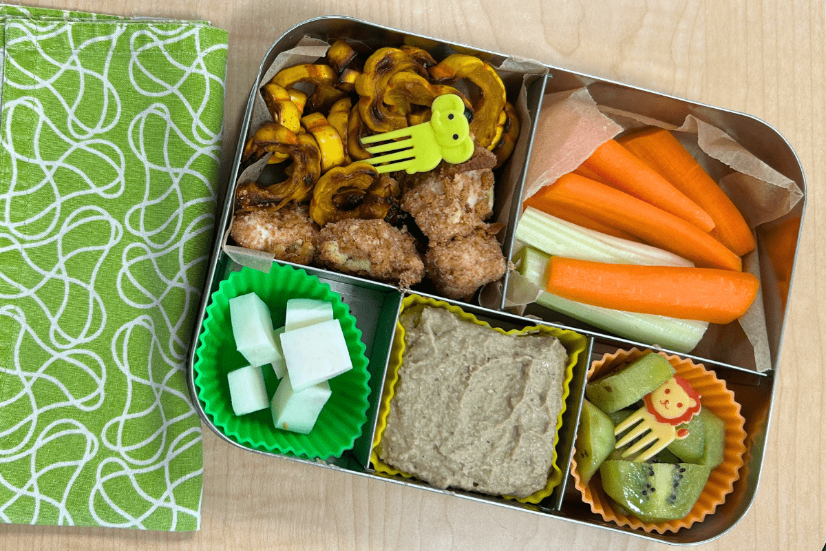 Lunch box with fruit, vegetables, and animal toys