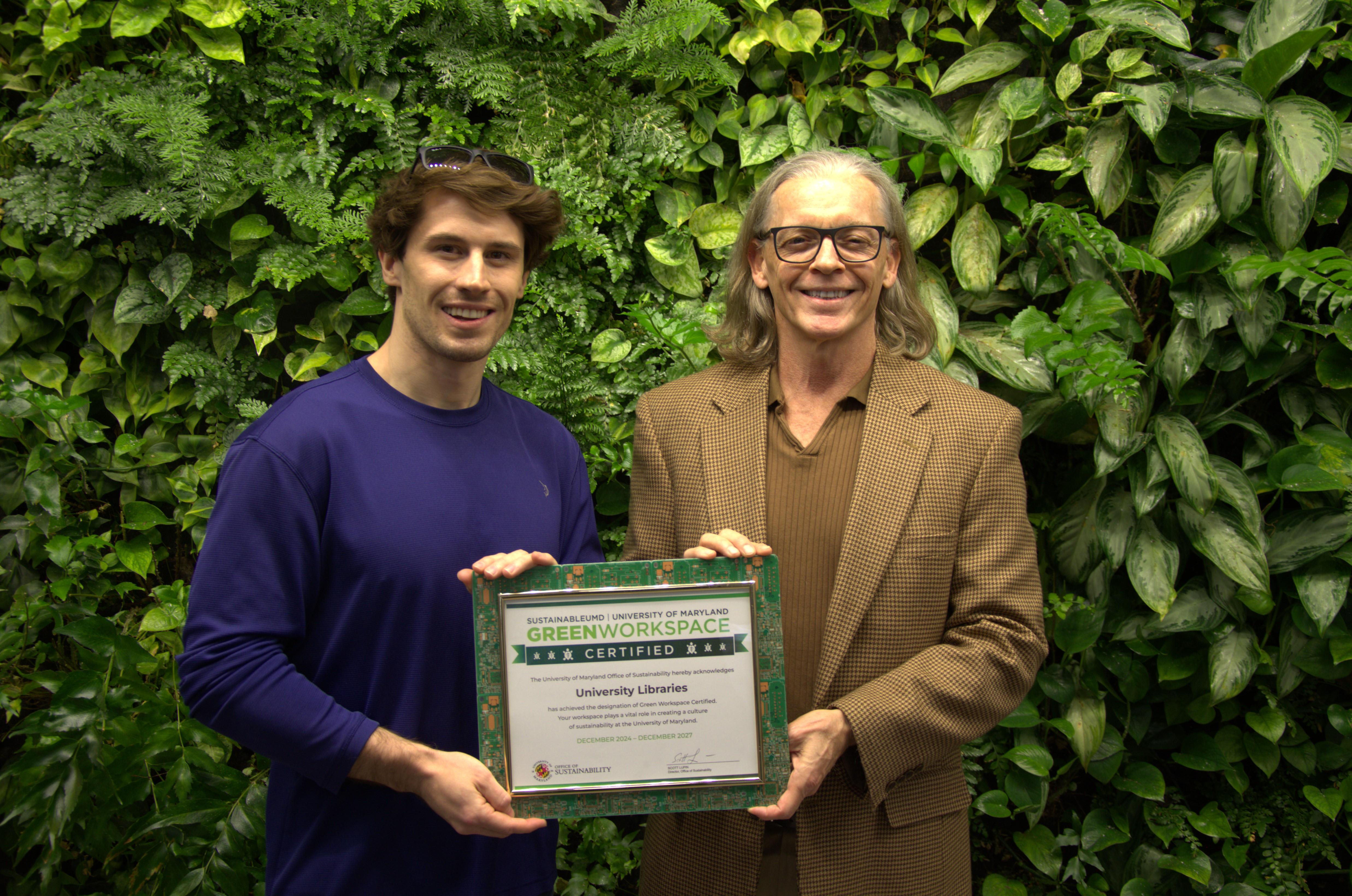 Two people holding Green Workspace certificate 