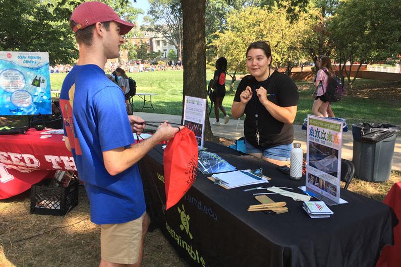 Student talking to a sustainability advisor outside