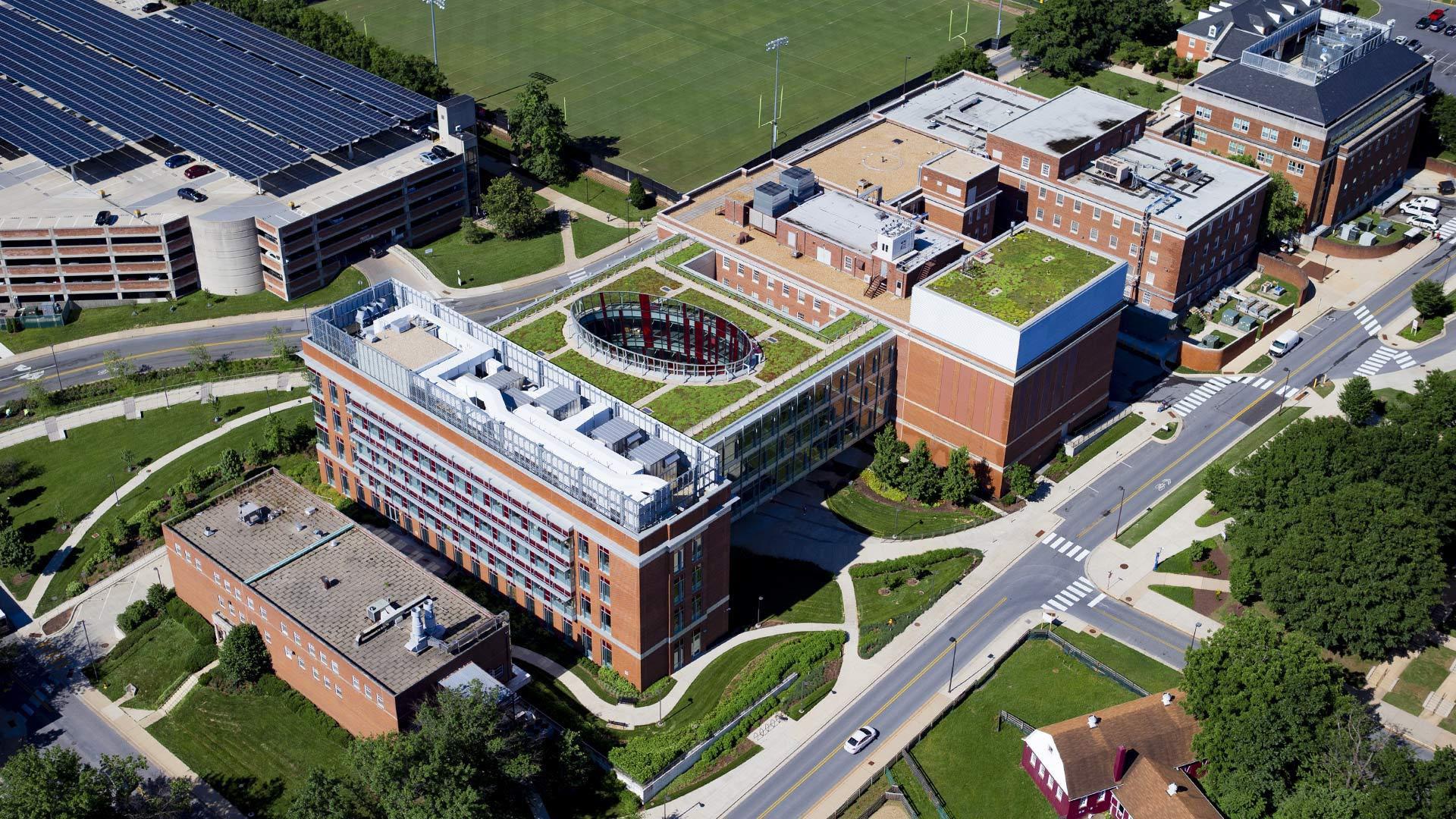 Aerial shot of buildings, green space and solar panels