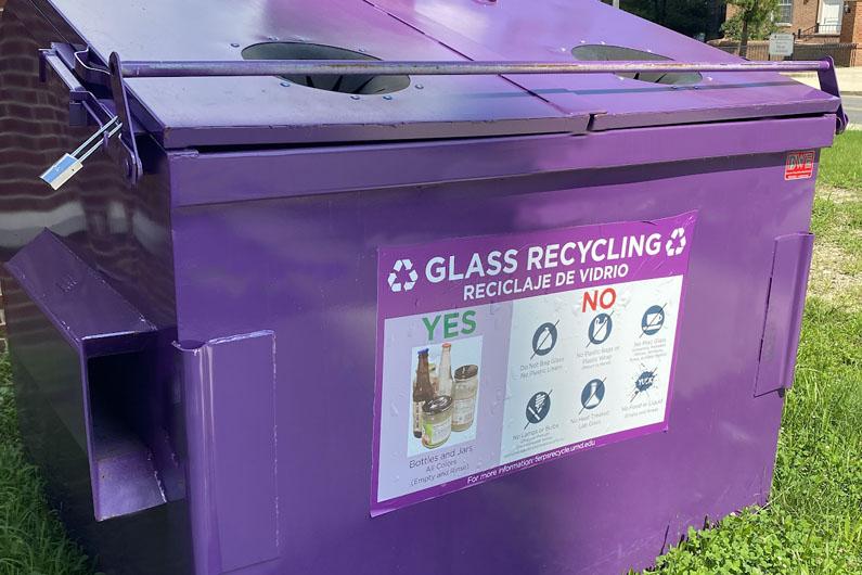 Purple glass recycling dumpster