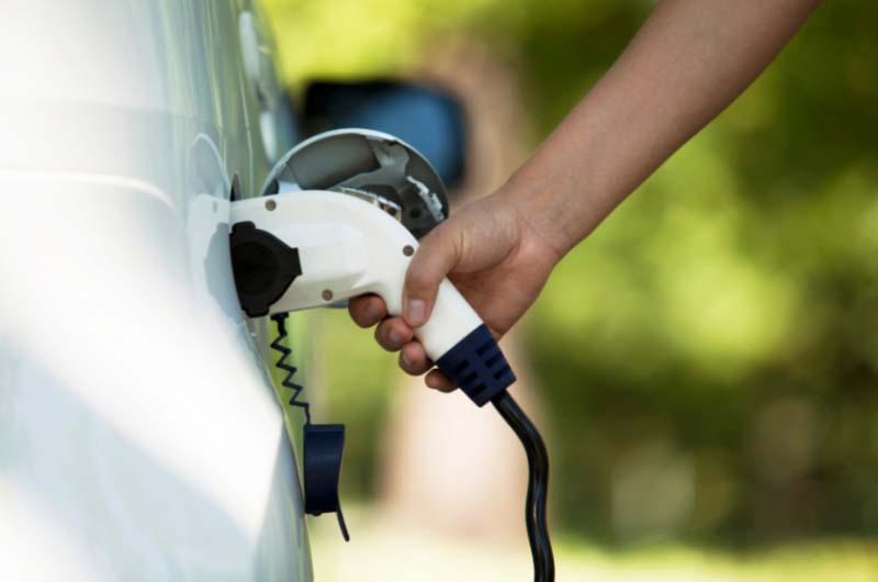 Plugging in an electric car to charge