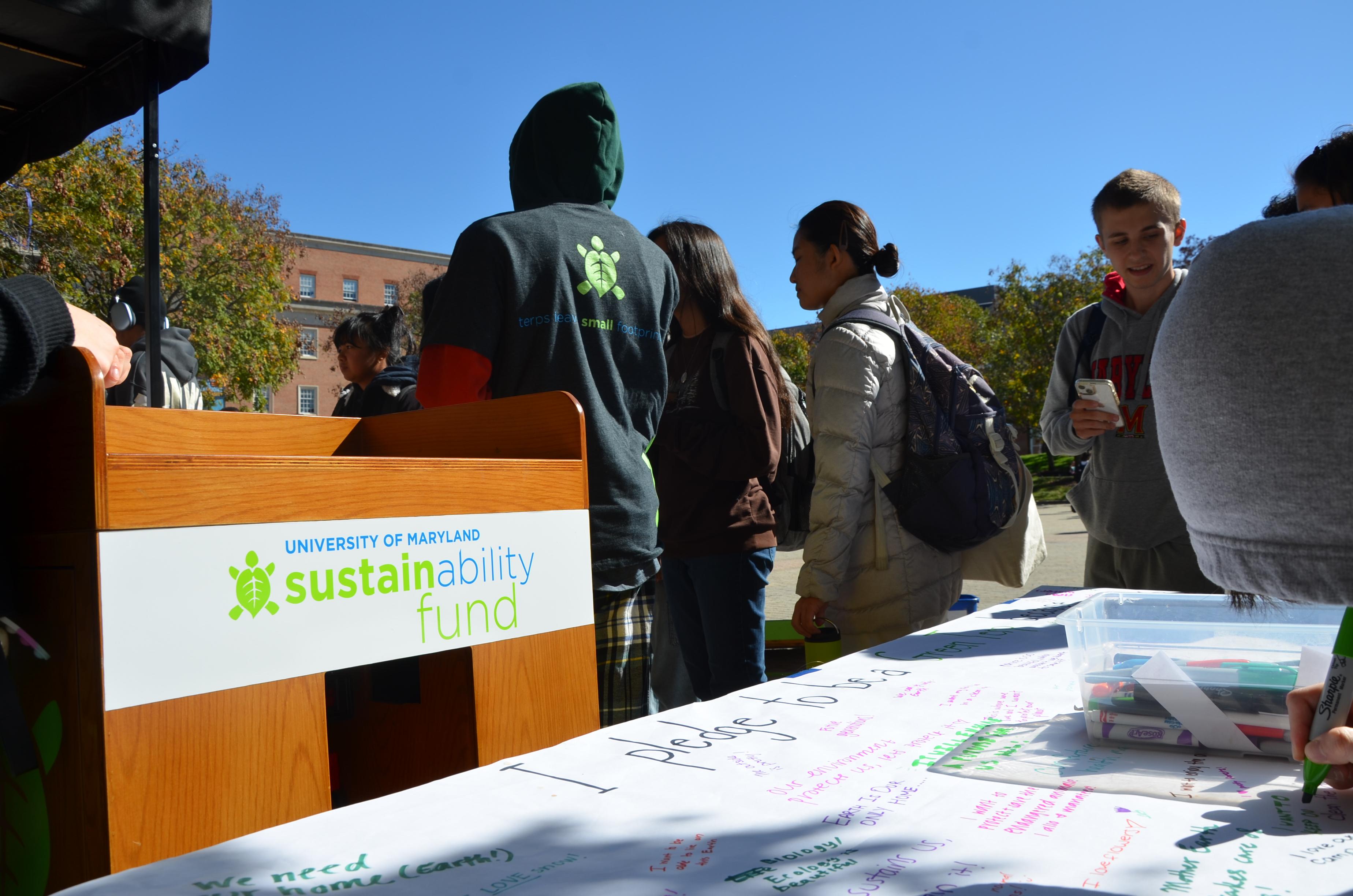 Image of the Outreach Bike and students standing around it