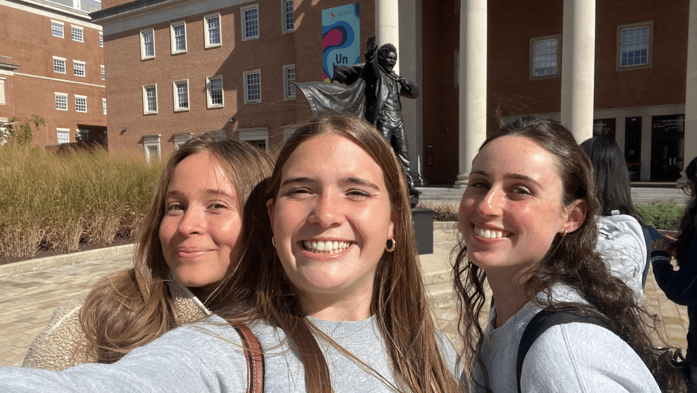 3 students standing in front of the Frederick Douglass Statue