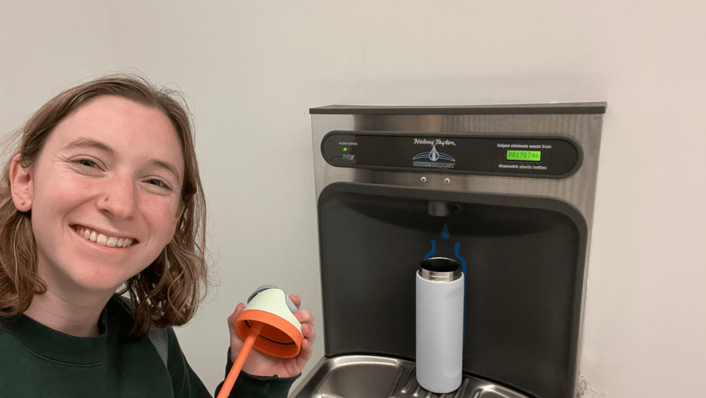 student refilling their reusable water bottle at a water refill station on the UMD Campus