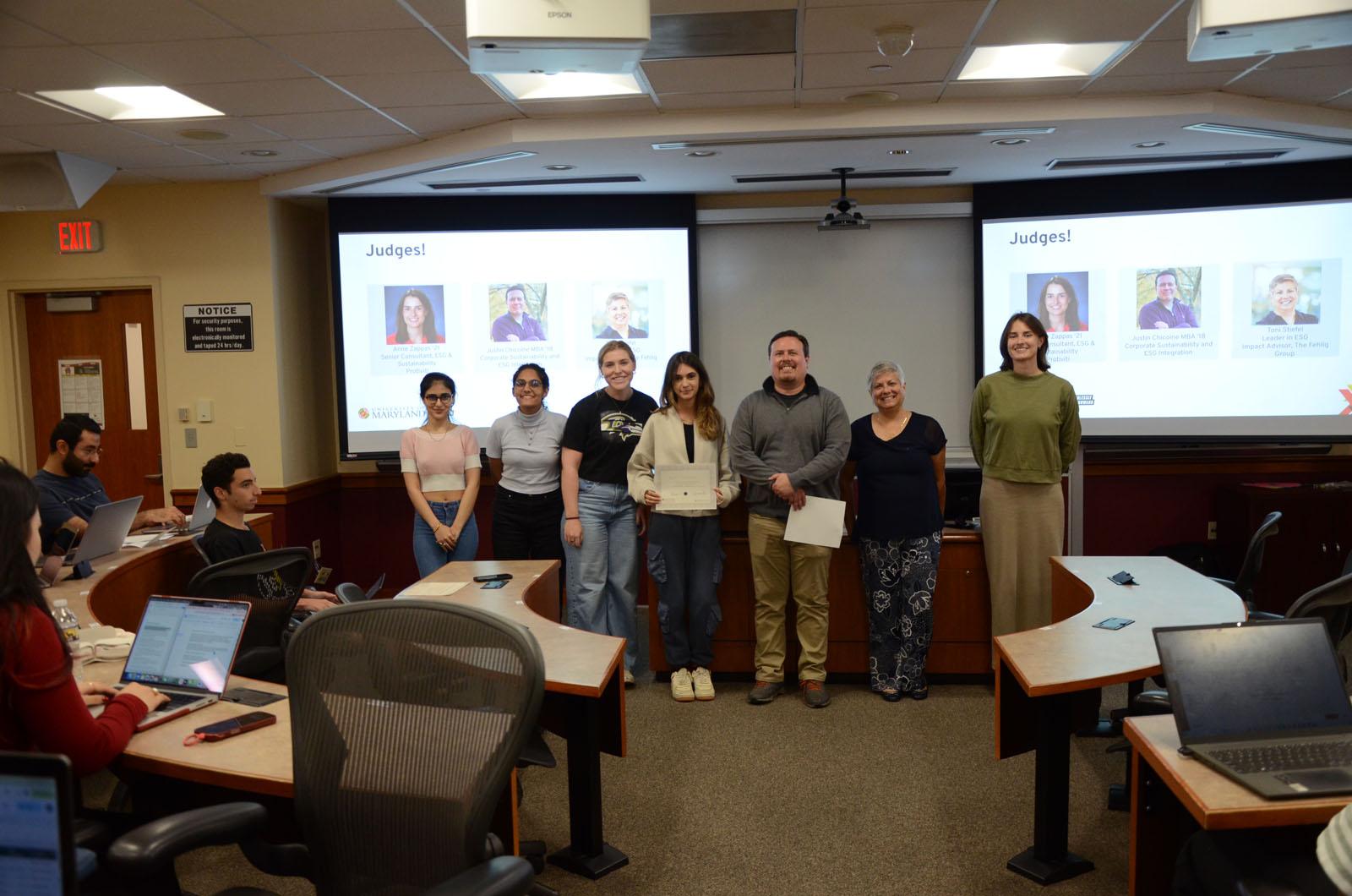 Judges and students smiling for award presentation