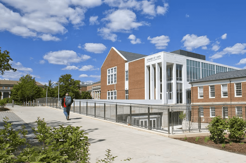 A student in front of Edward St.. John building 